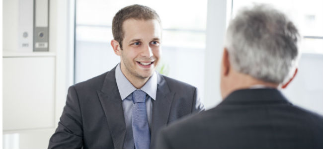 A young businessman talking to a professional mentor.