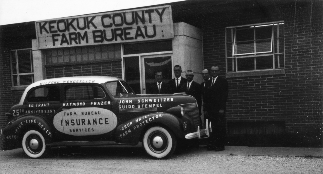 Old Farm Bureau photo of five men and FB car in front o